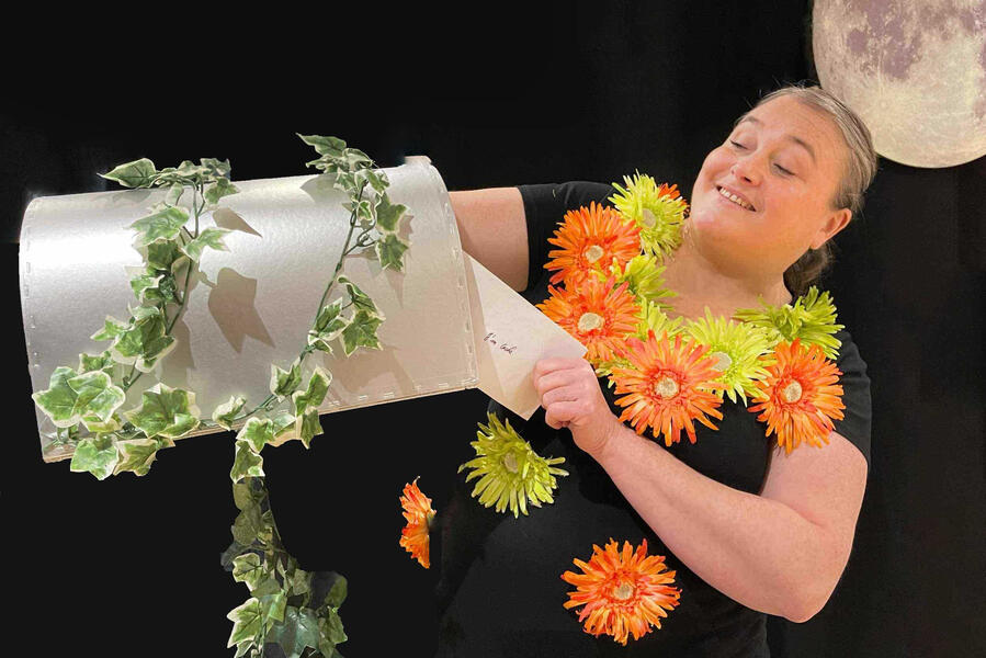 Aurore, la comédienne ouvre sa boîte aux lettres magique et sort son courrier imaginaire pour raconter des histoires aux enfants lors d'un spectacle pour un homme de Noël pour une mairie